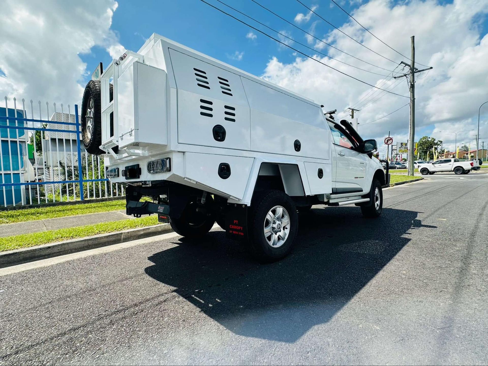 White Utility Truck on a Street With a Large Storage Compartment on the Back — PT Canopy In Slacks Creek, QLD