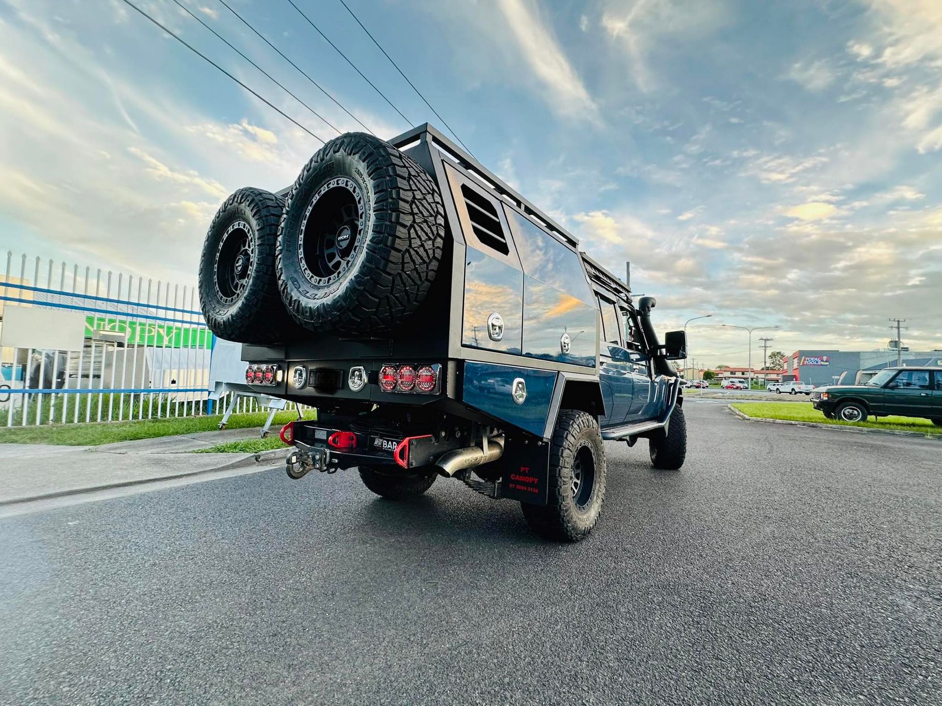 Blue Off-road Truck With Aluminium Tray and Canopy Parked on Asphalt — PT Canopy In Slacks Creek, QLD