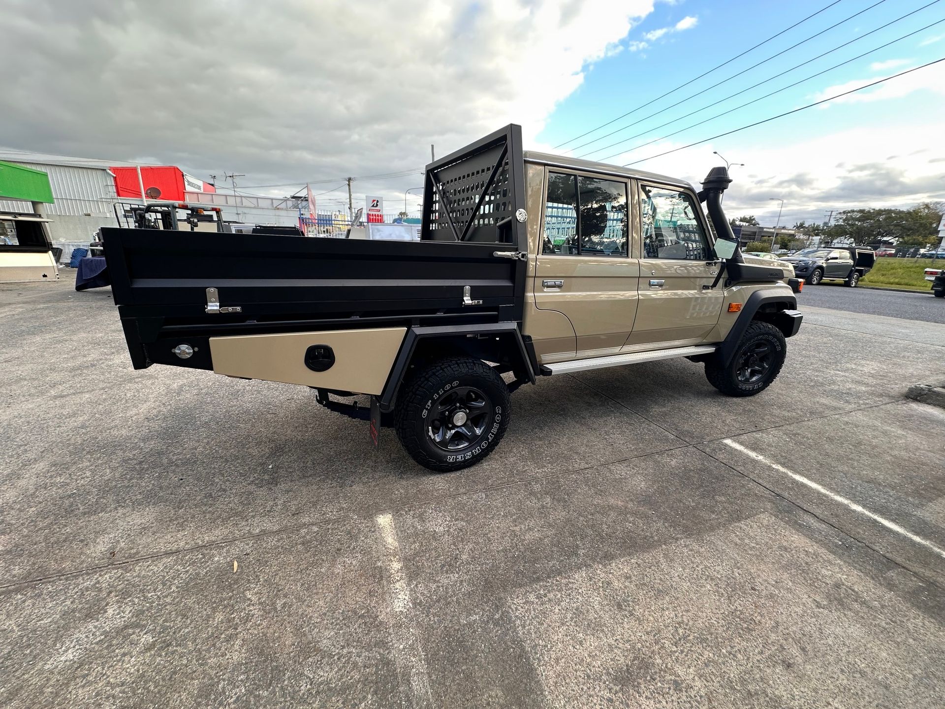 Tan Utility Truck With a Black Flatbed, Parked Outdoors on Asphalt — PT Canopy In Slacks Creek, QLD