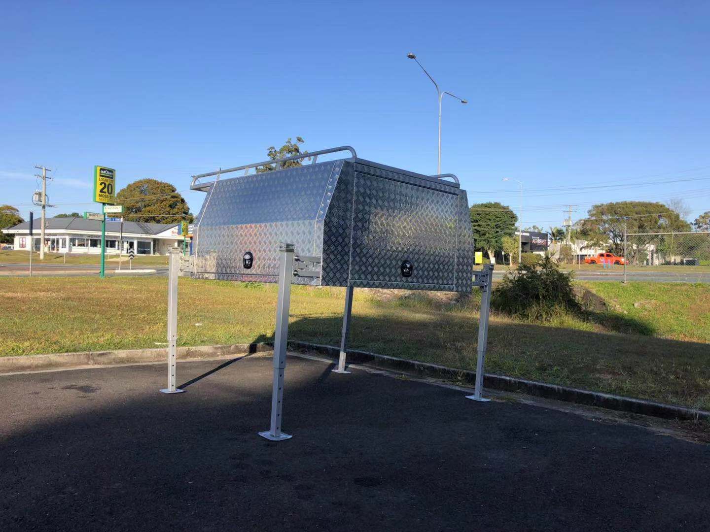 Shiny Aluminum Truck Bed Camper on Metal Posts — PT Canopy In Slacks Creek, QLD