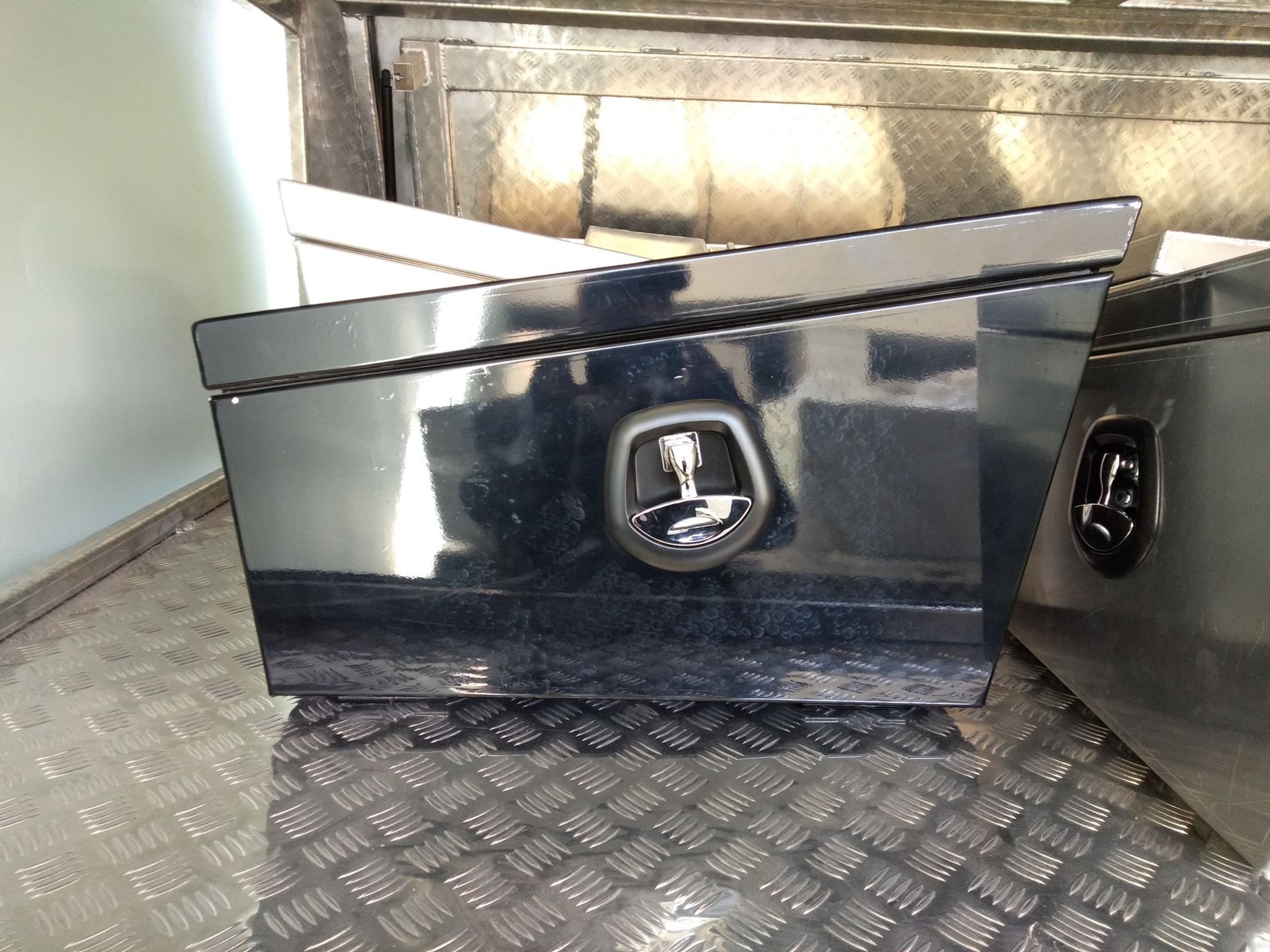 Black Toolbox With a Sloped Lid on a Metal Surface With a Diamond Plate Pattern — PT Canopy In Slacks Creek, QLD