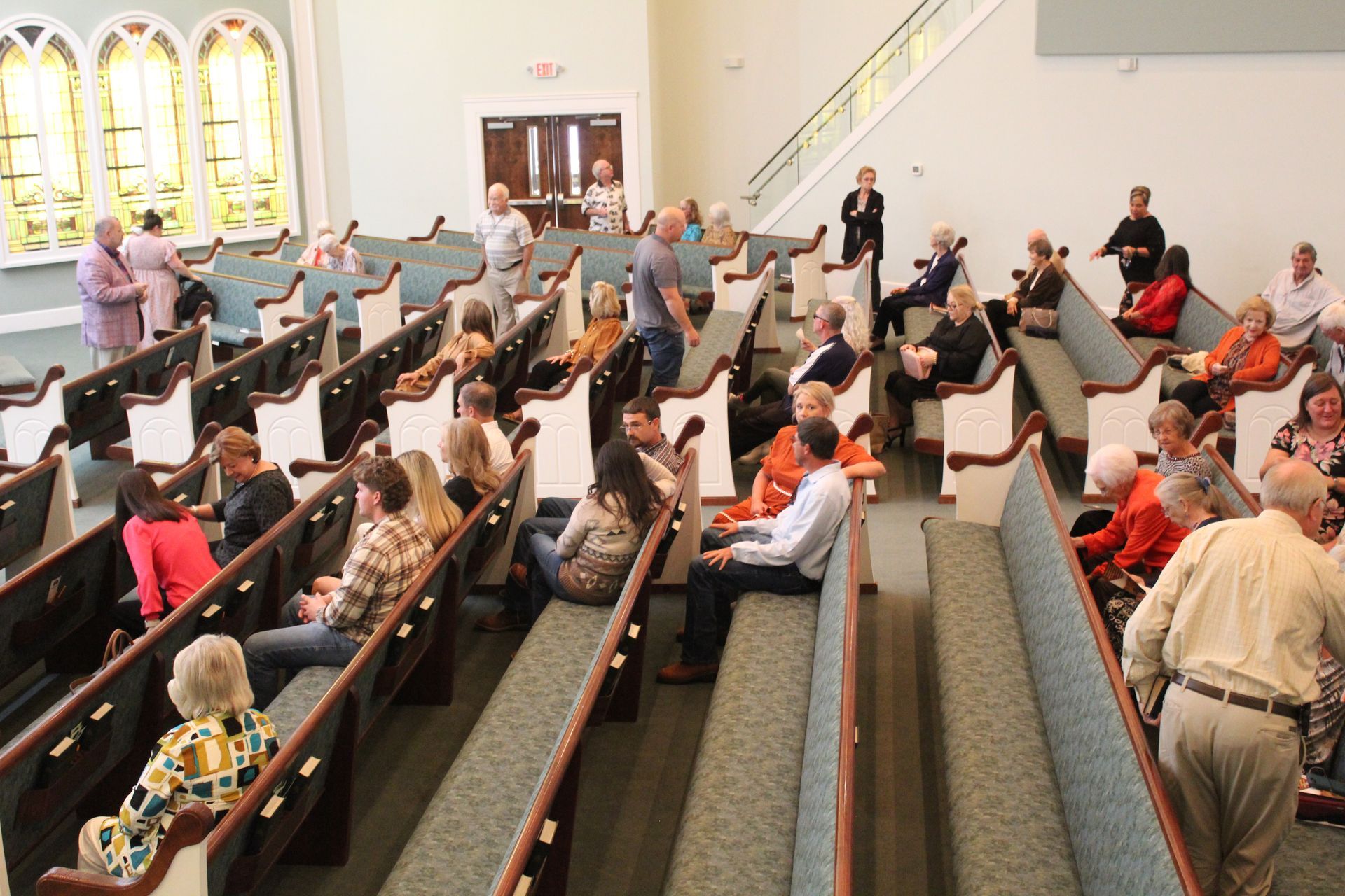 A large group of people are sitting in rows in a church