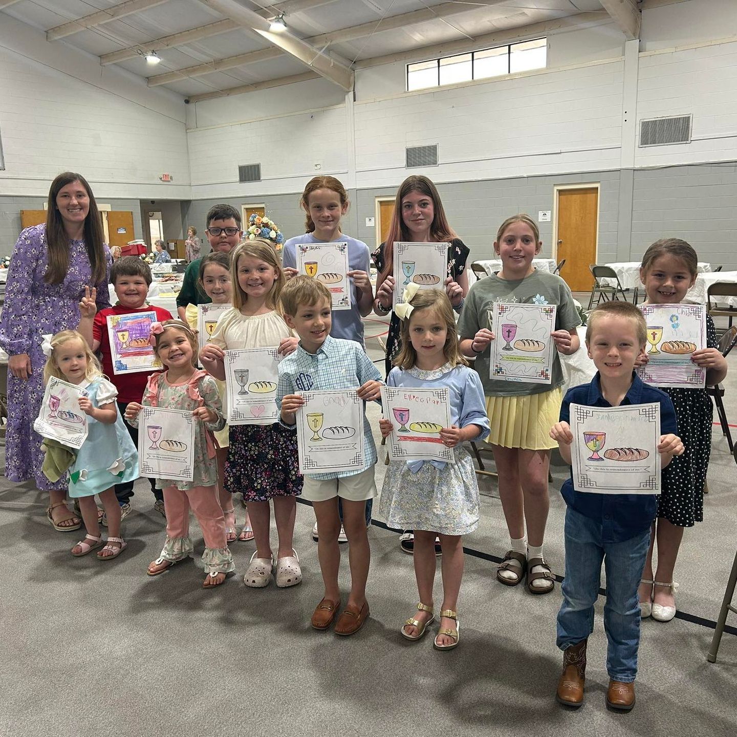A little girl is sitting in a chair on a rug