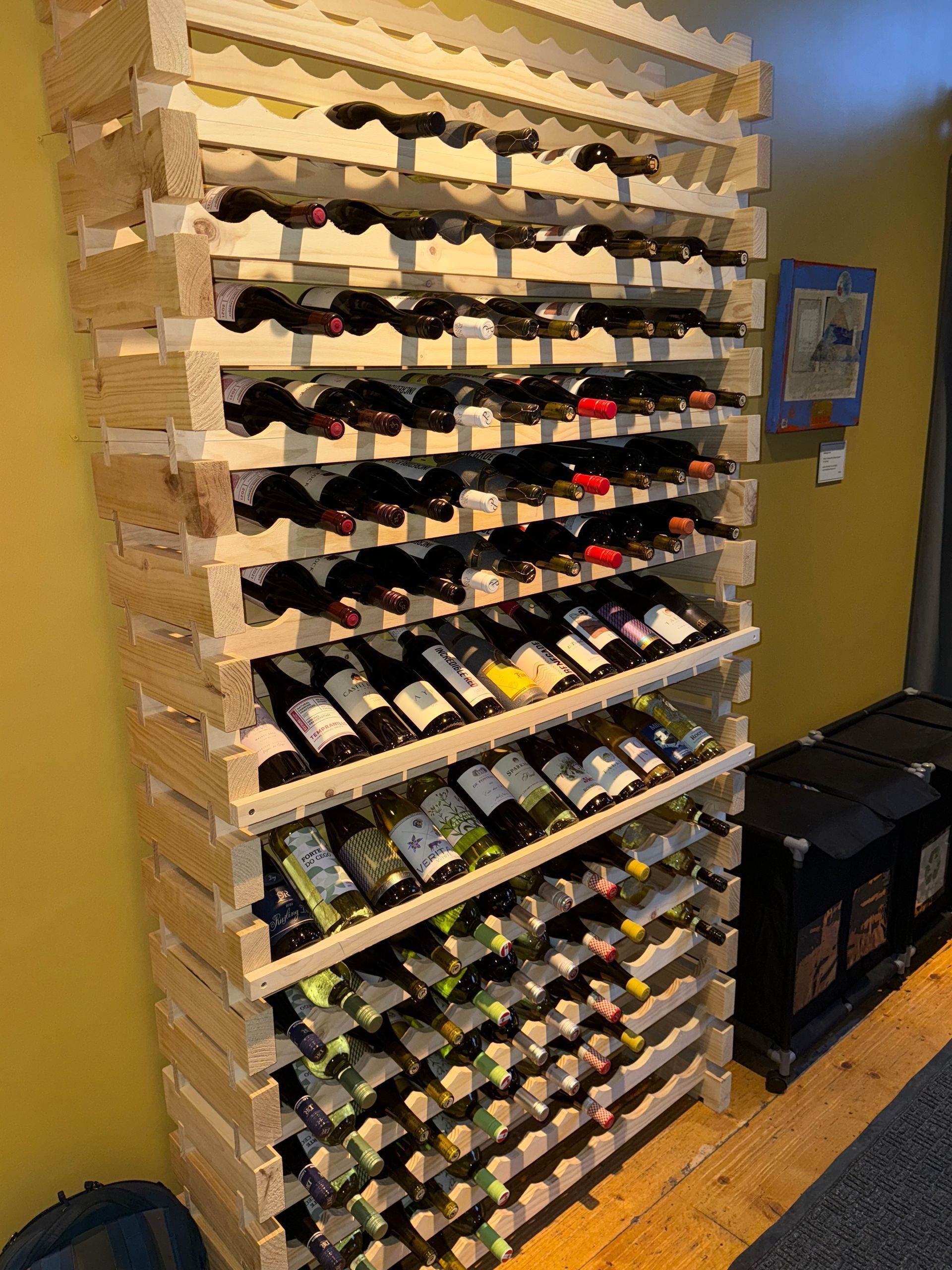 Wooden wine rack filled with various wine
