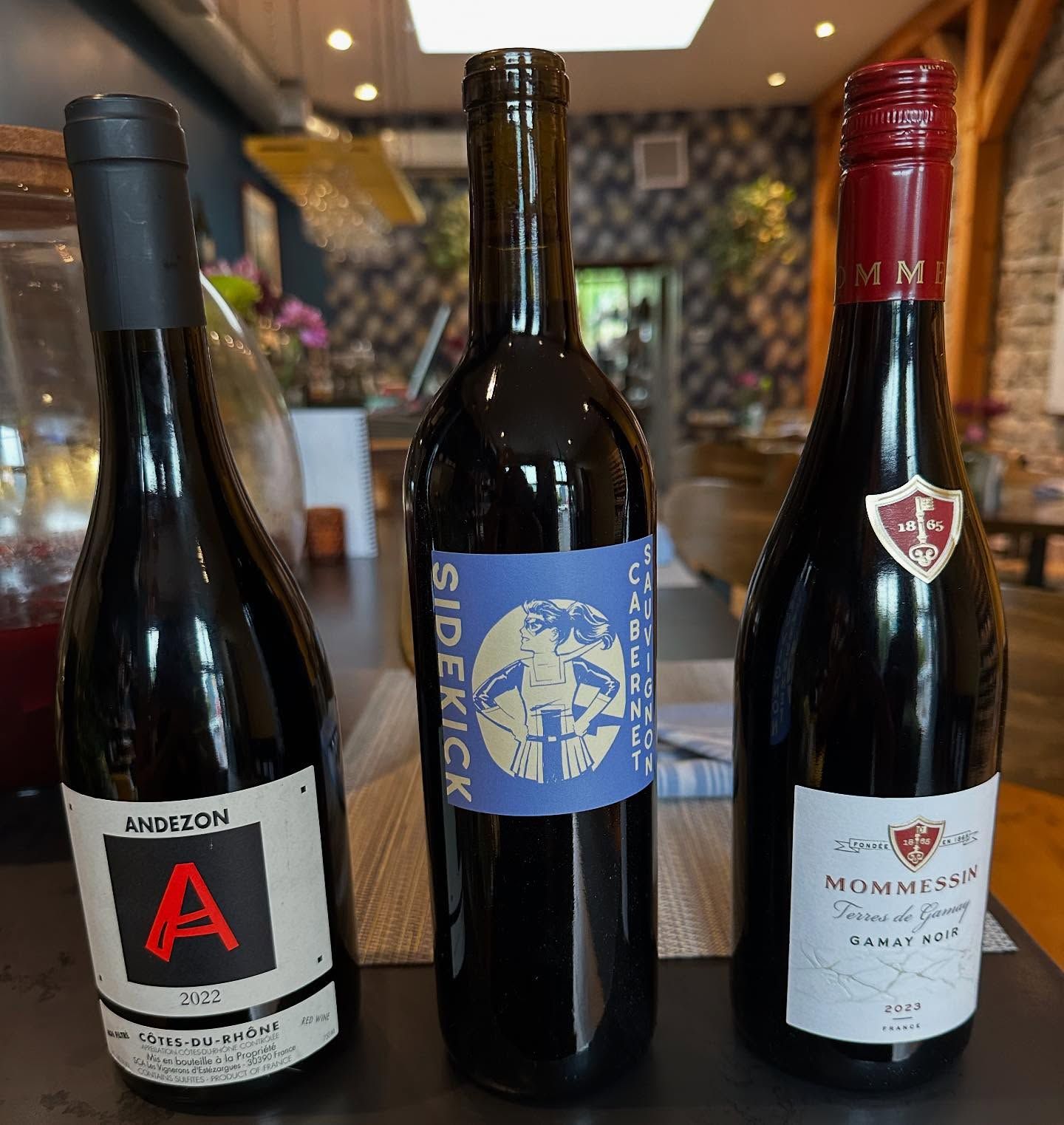 Three wine bottles on a table