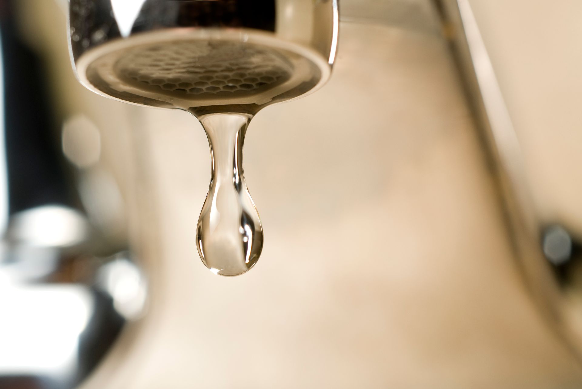 Drop of Water Is Dripping from A Faucet — Teaneck, NJ — Marvin Newman Plumbing & Heating