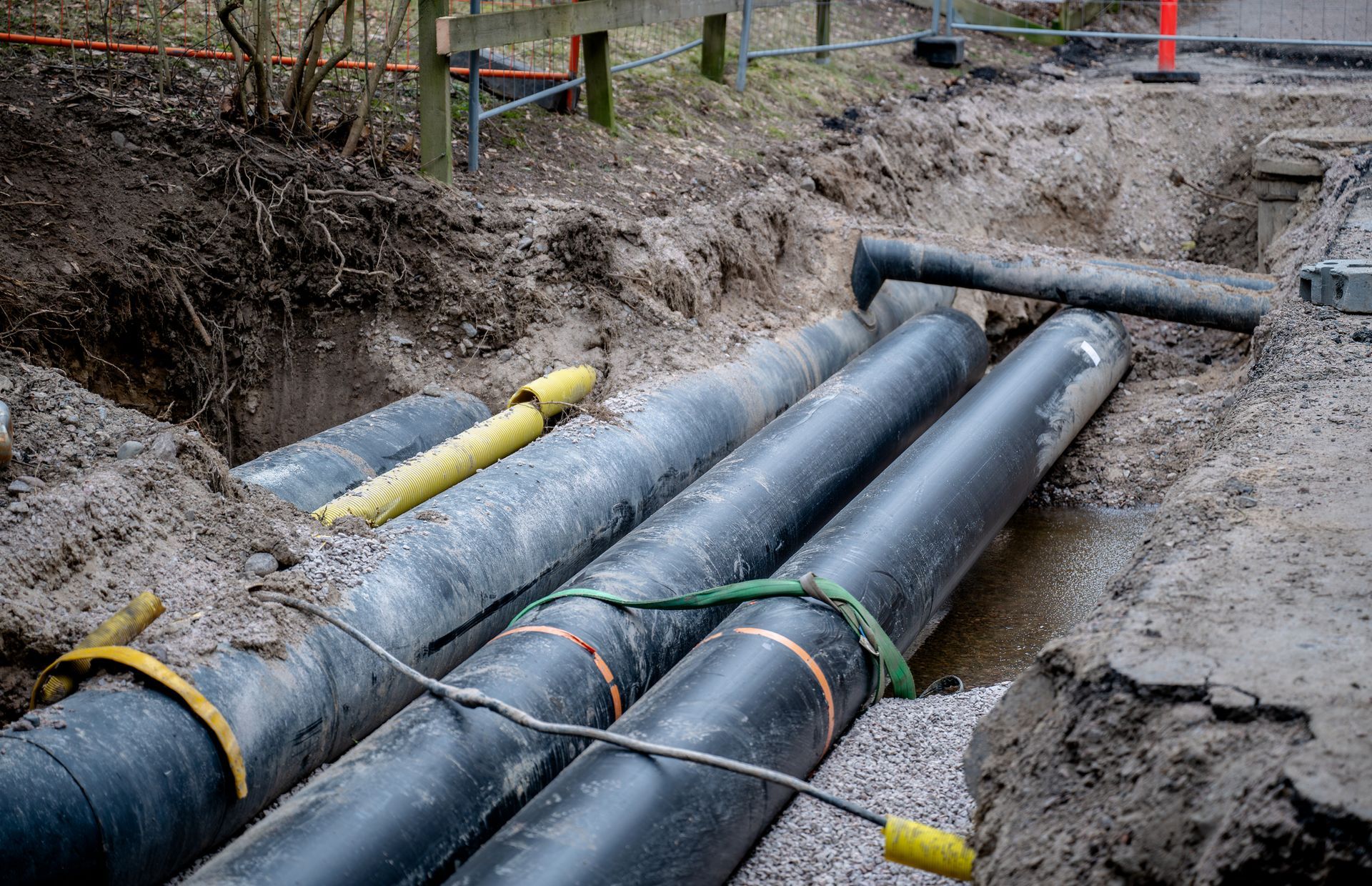 Pipes Laying in The Dirt — Teaneck, NJ — Marvin Newman Plumbing & Heating