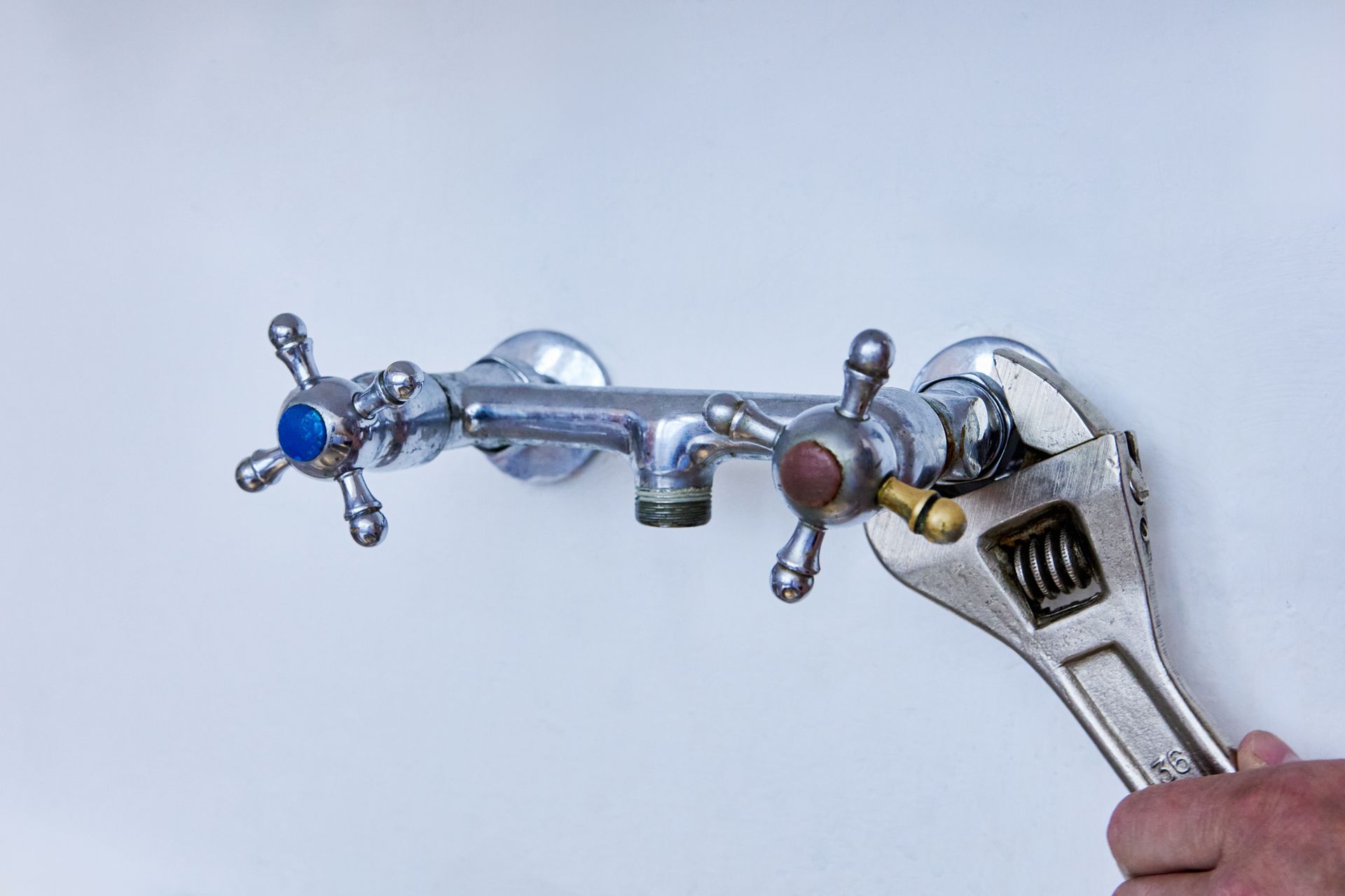 Fixing a Faucet with A Wrench — Teaneck, NJ — Marvin Newman Plumbing & Heating