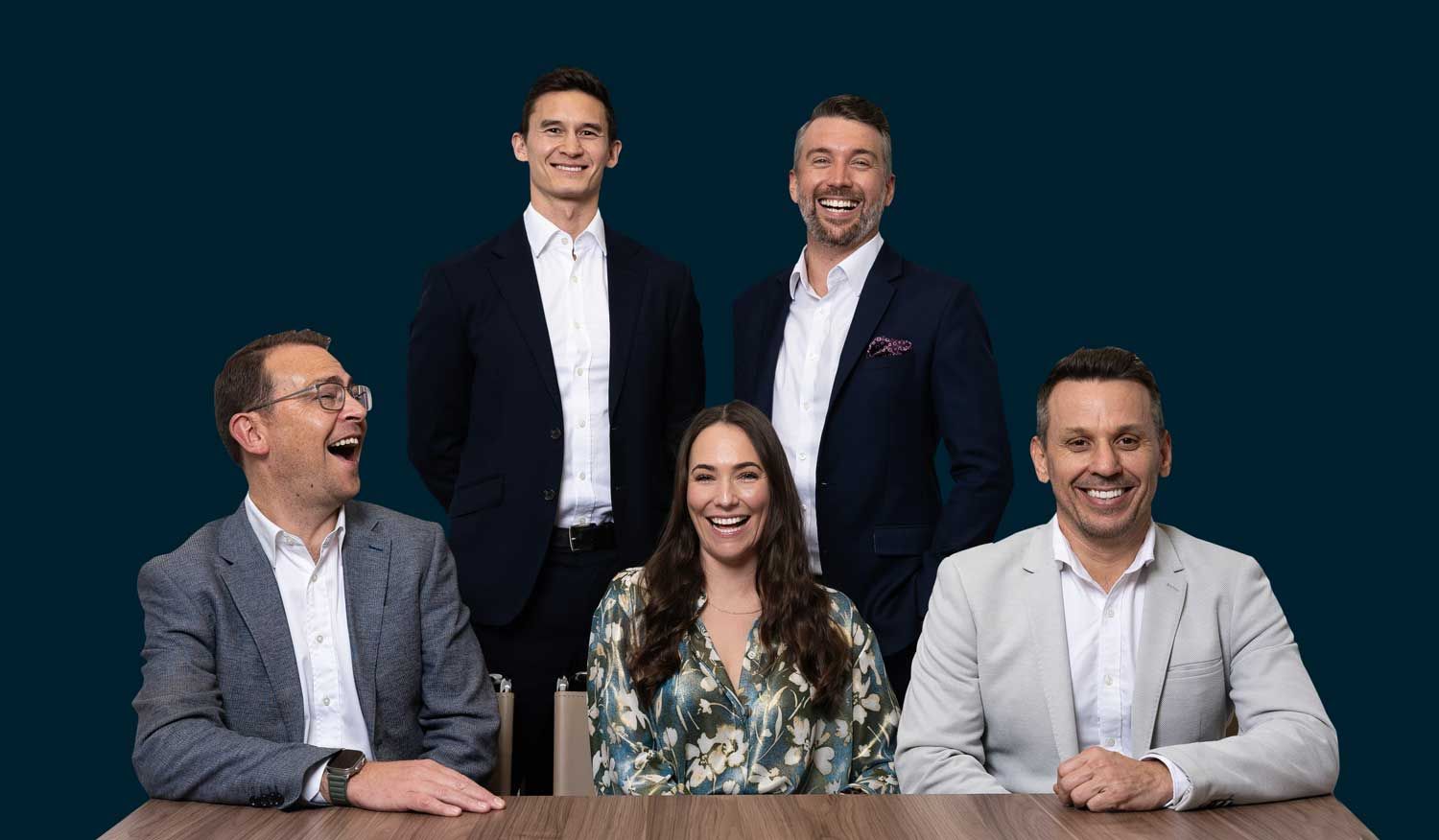 Lanson Partners team posing for a picture while sitting at a table