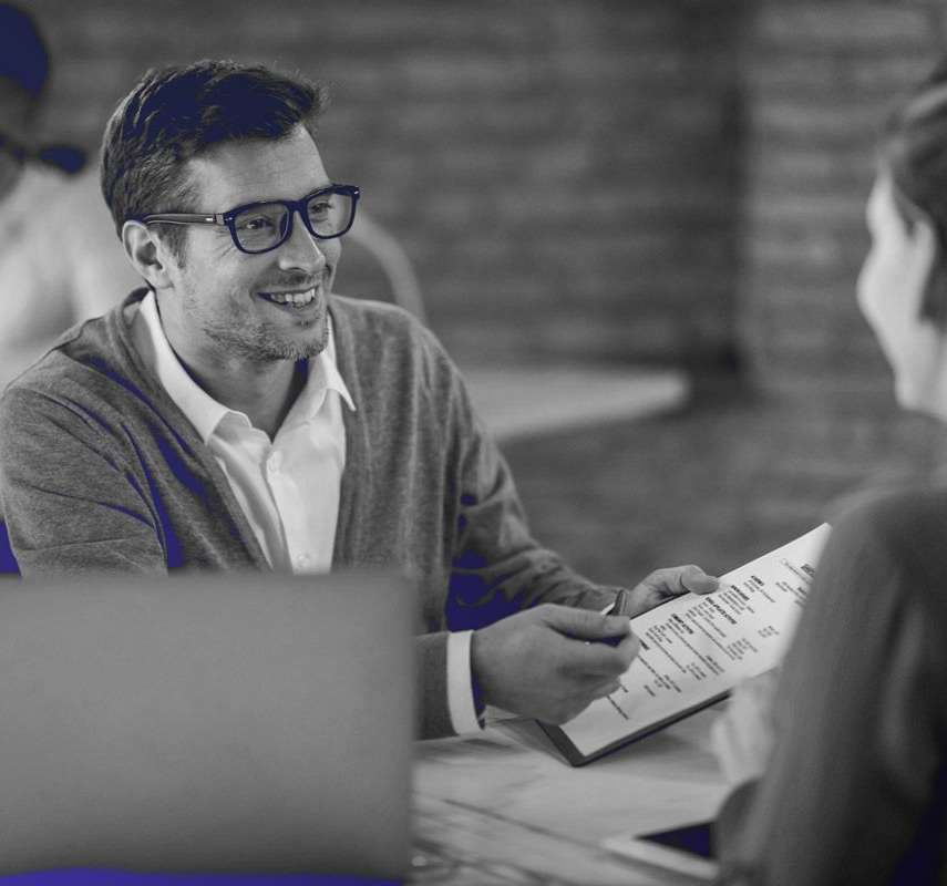 Lanson Partners team posing for a picture while sitting at a table