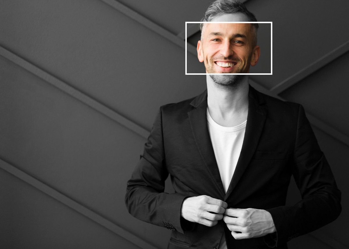 A specialist recruiter in a suit is smiling