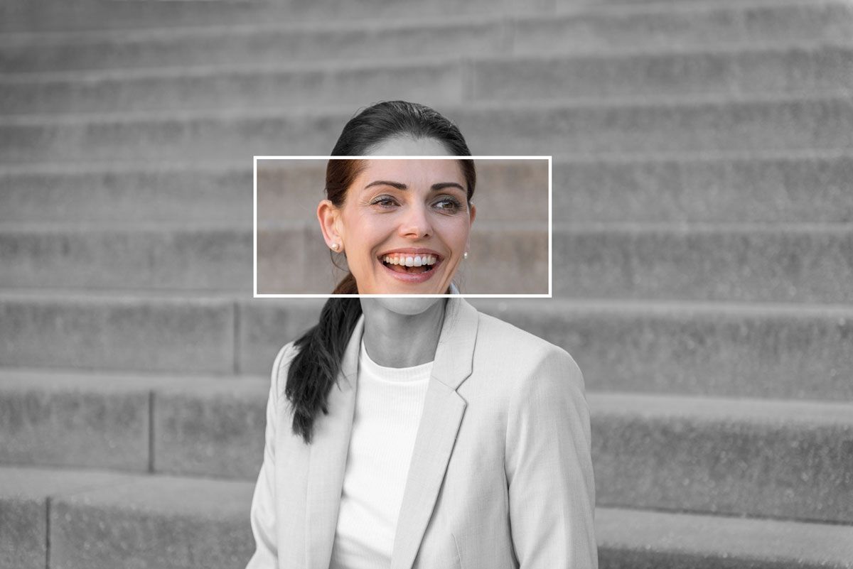 A change management recruitment specialist in a suit is smiling