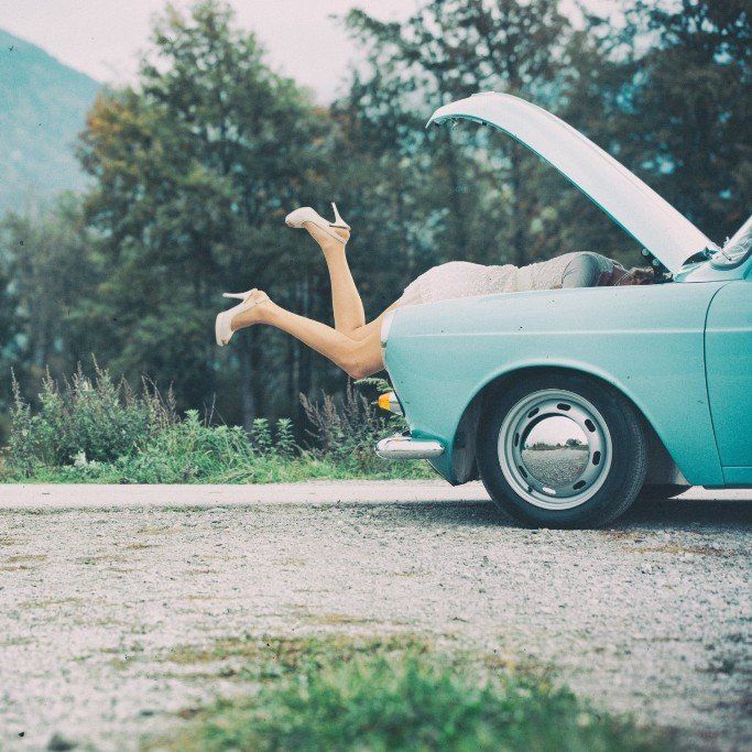 pair of legs with white high heels on in boot of green vintage car in countryside, Cotswold Tiger, The Second Home Company