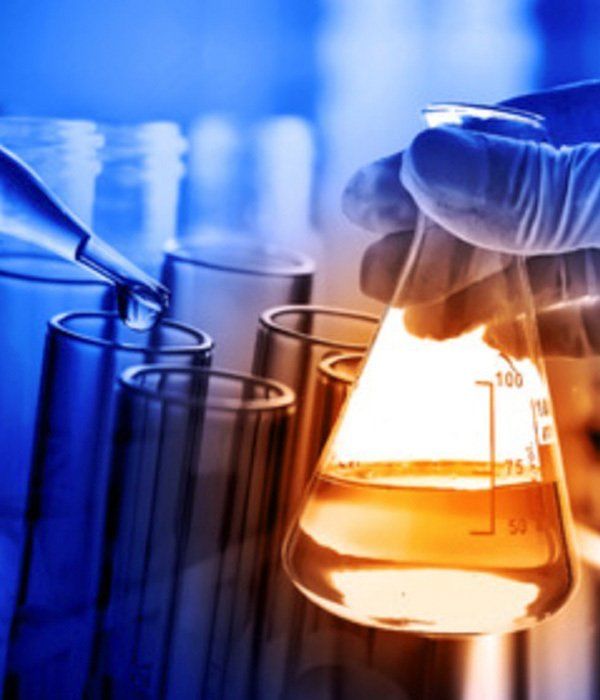 A person is pouring liquid into a beaker with a pipette