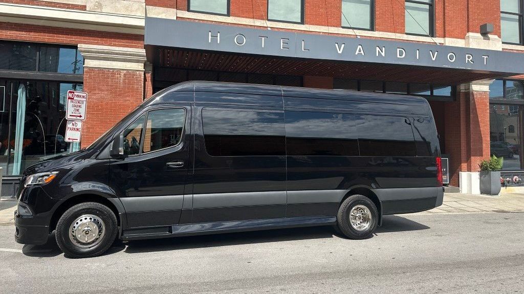 a black van is parked in front of a hotel