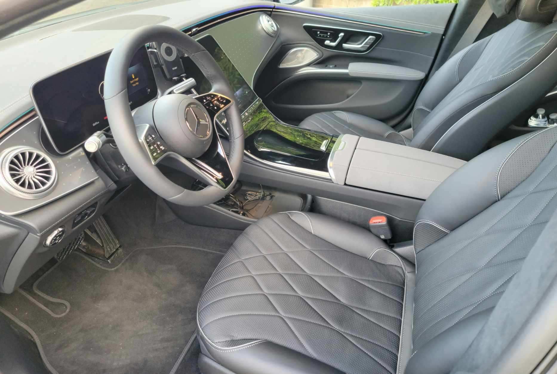the interior of a car with a steering wheel and seats .