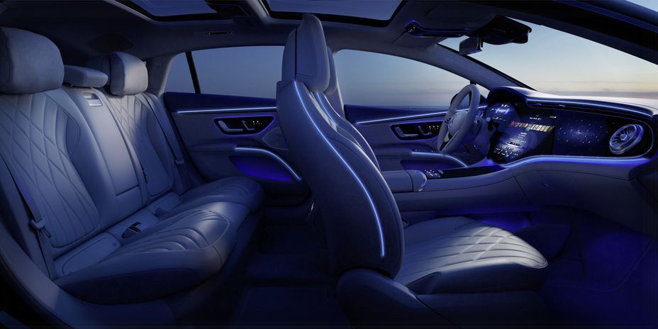 the interior of a mercedes benz eqs is shown at night .