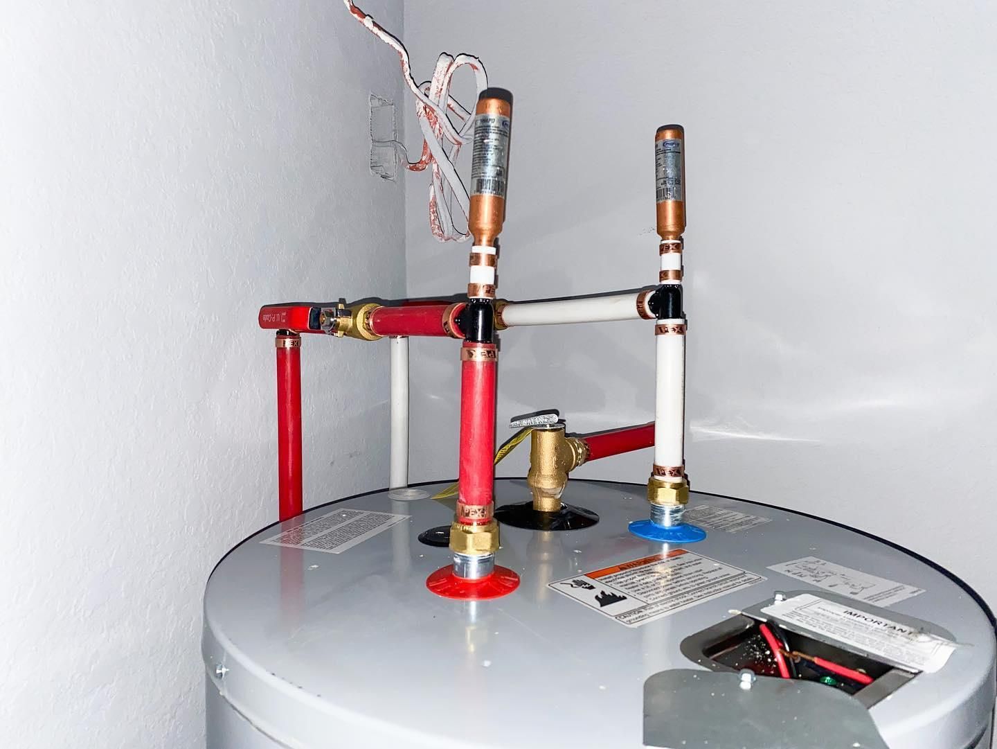 A water heater is sitting in a corner of a room.