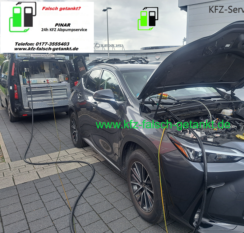 A service vehicle pumps fuel from a gray car with its hood open, provided by a mobile wrong-fuel removal service.