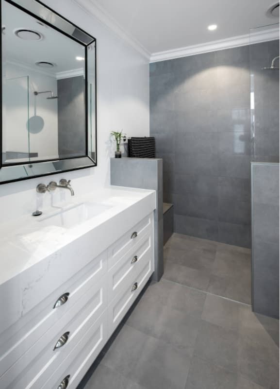 A Bathroom With A Sink A Mirror And A Walk In Shower — Hutchisons Tile Centre In Gold Coast, QLD