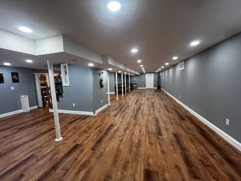 A basement with hardwood floors and gray walls