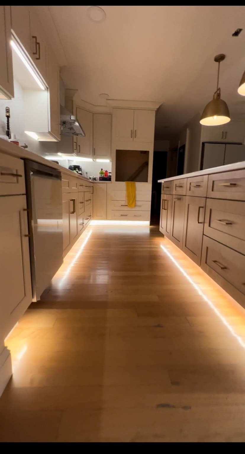 A kitchen with a wooden floor and a lot of cabinets