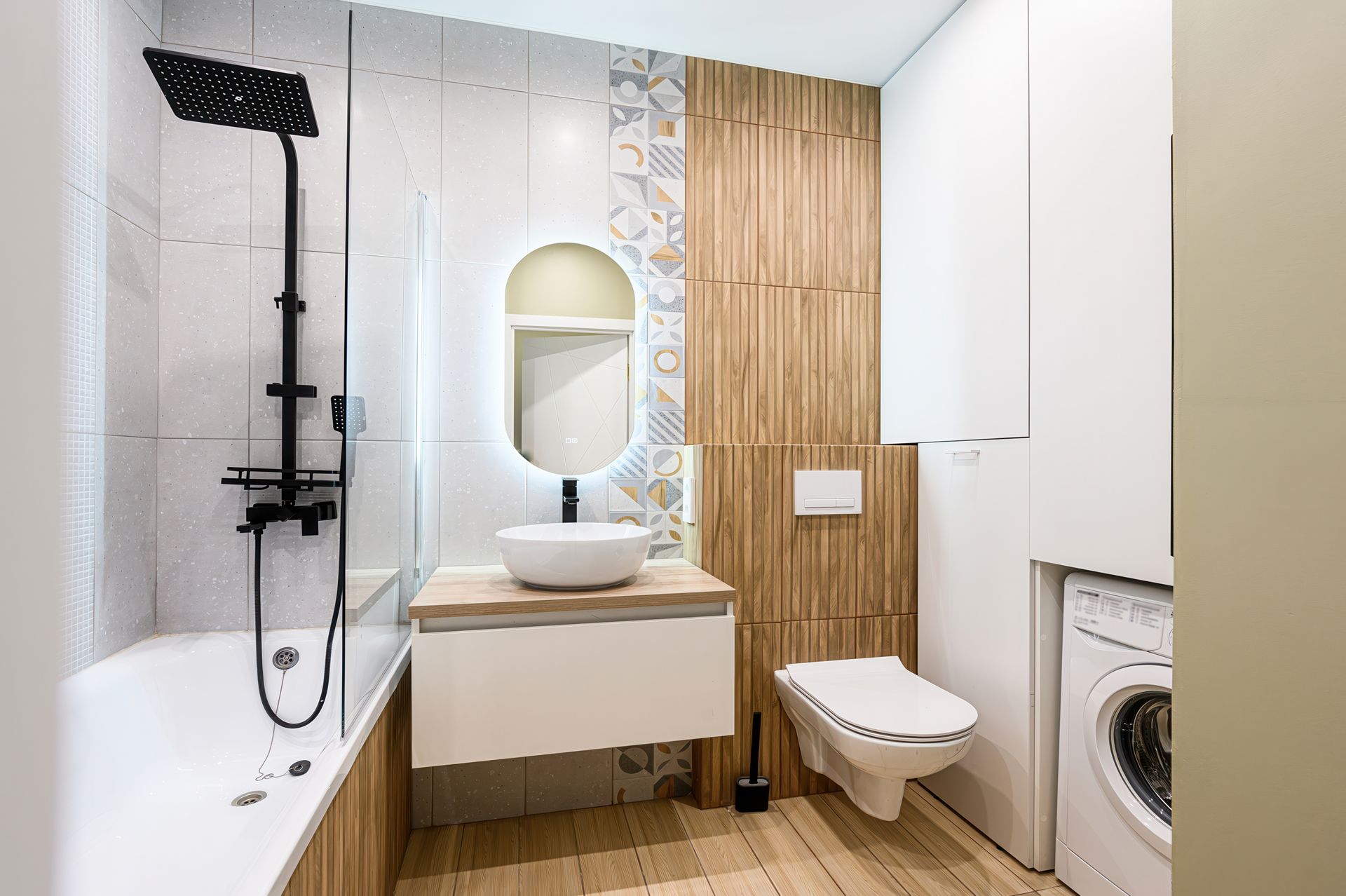 Modern bathroom with a bathtub, shower, toilet, and sink, featuring wood and white accents.
