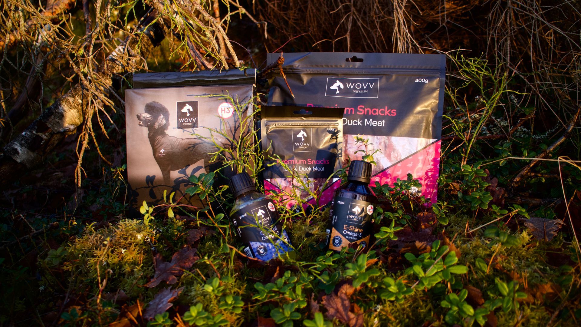 Three black and pink bags of dog snacks, each with a different meat listed.