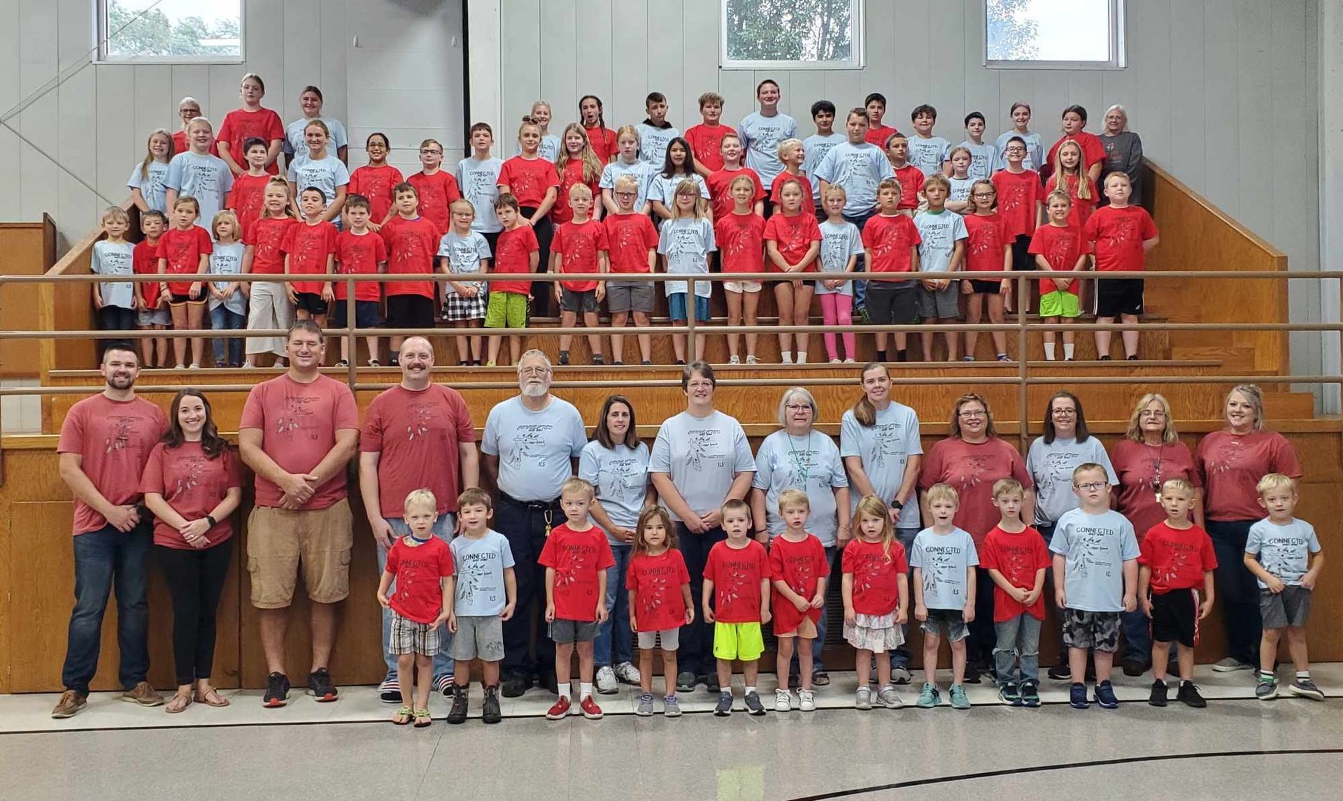 Immanuel Lutheran students and staff posing for a picture in a gym.