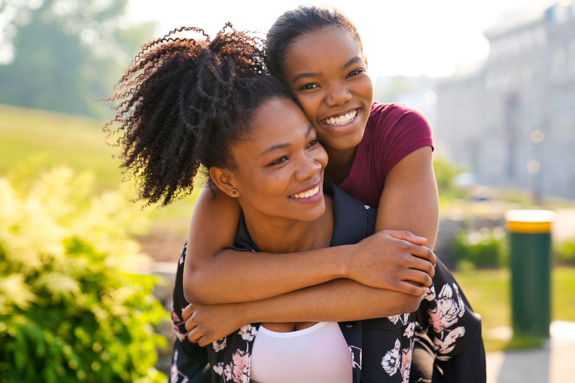 african-american teen girl hugging her mother