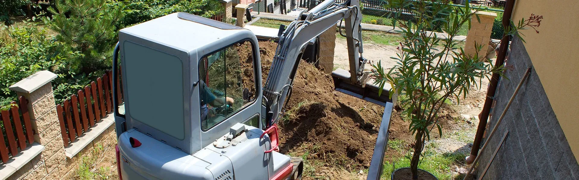 A small excavator is digging a hole in the ground.