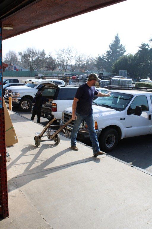 Man Passing by Parked Vehicles — Escalon, CA — Escalon Feed & Supply