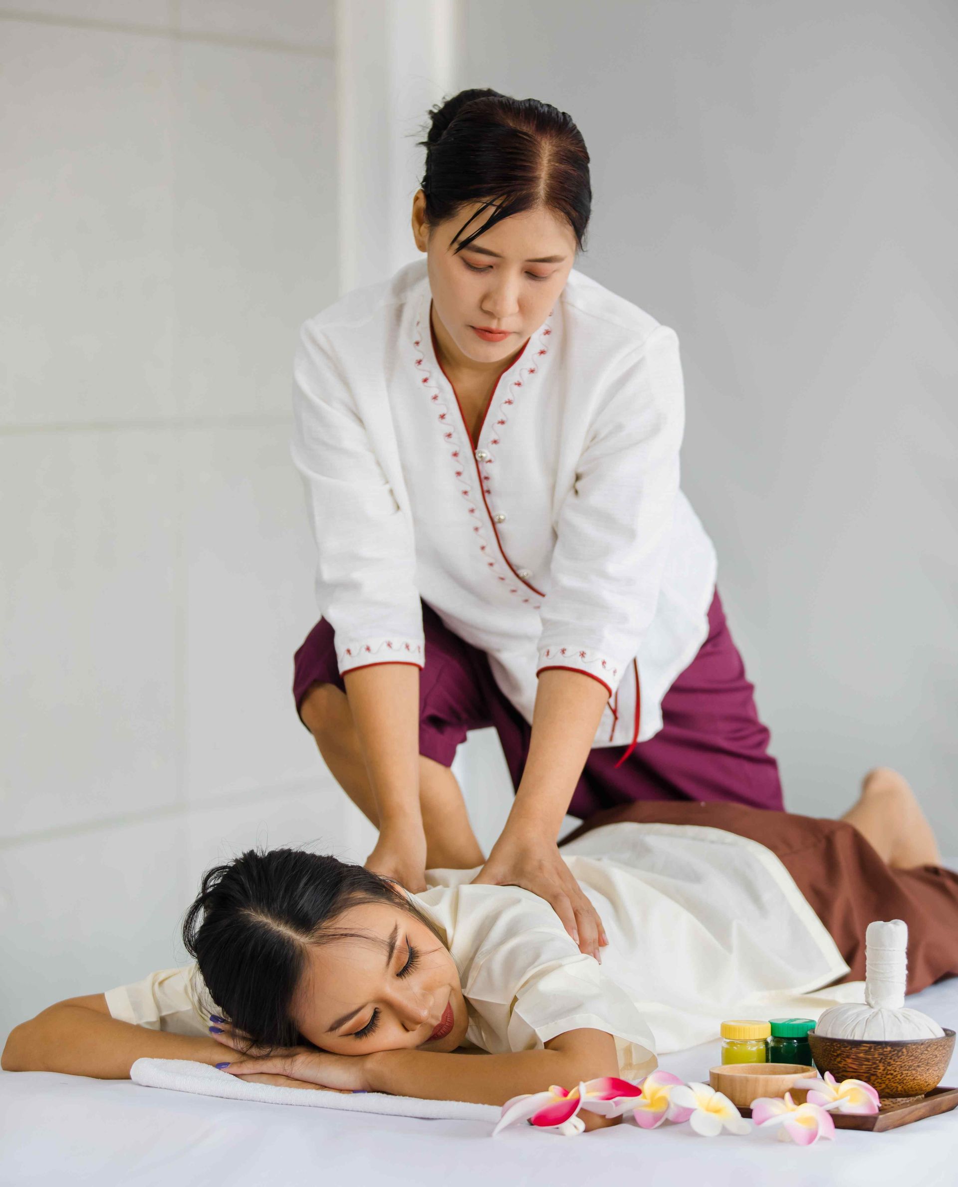 Massage Therapist using both hands to massage upper back