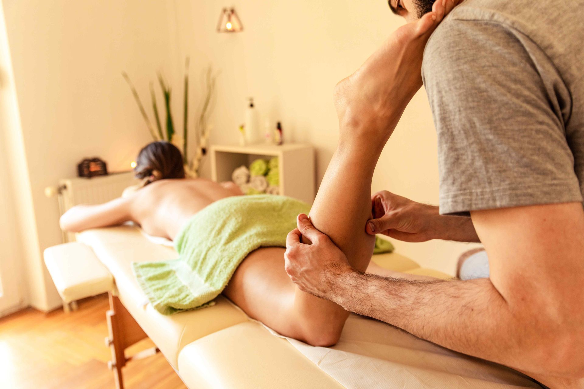 Massage Therapist massaging calves