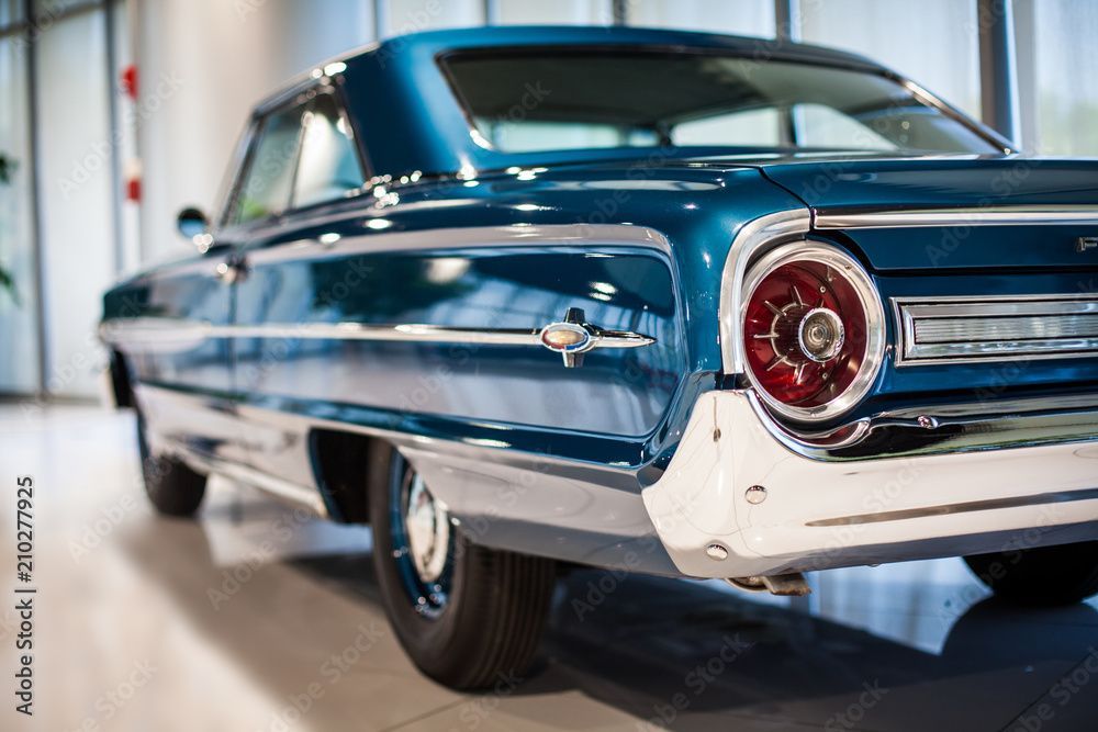 Blue vintage Ford car, rear view, in a showroom, chrome details, round taillight. | General Automotive Services