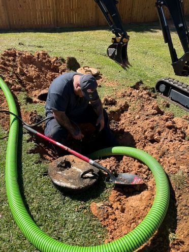 Spraying out a septic tank with water