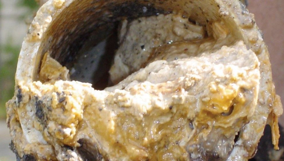 a close up of a dirty pipe with a lot of greese in it