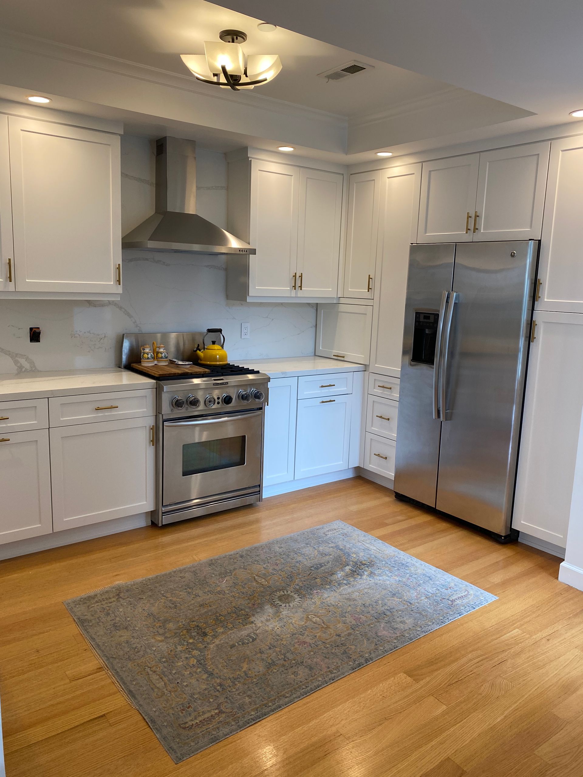 A kitchen with stainless steel appliances and white cabinets