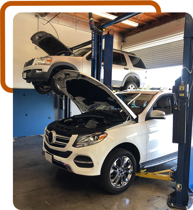 white cars on lift | Niko's Automotive Repair