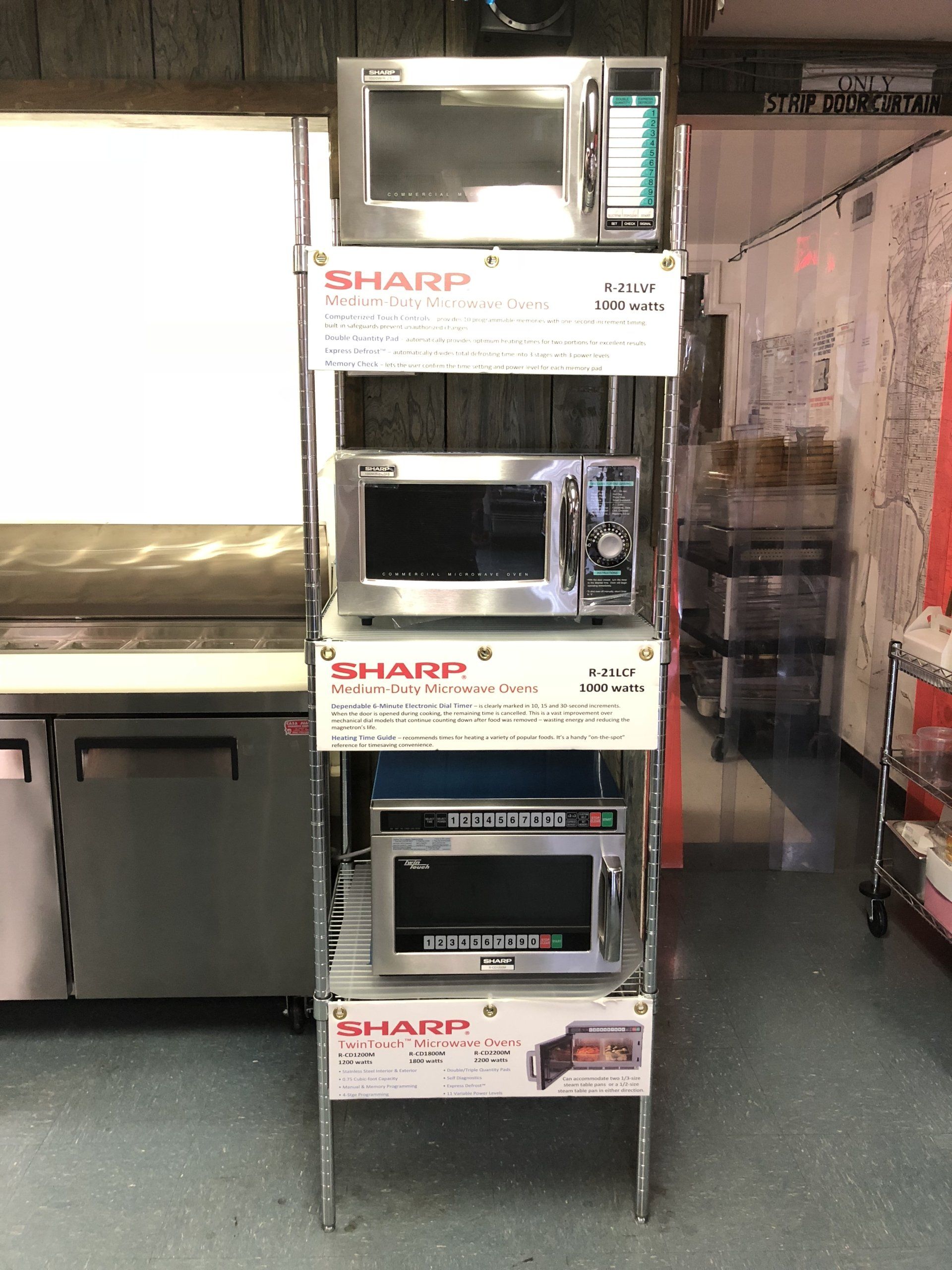 A display of sharp microwave ovens in a kitchen