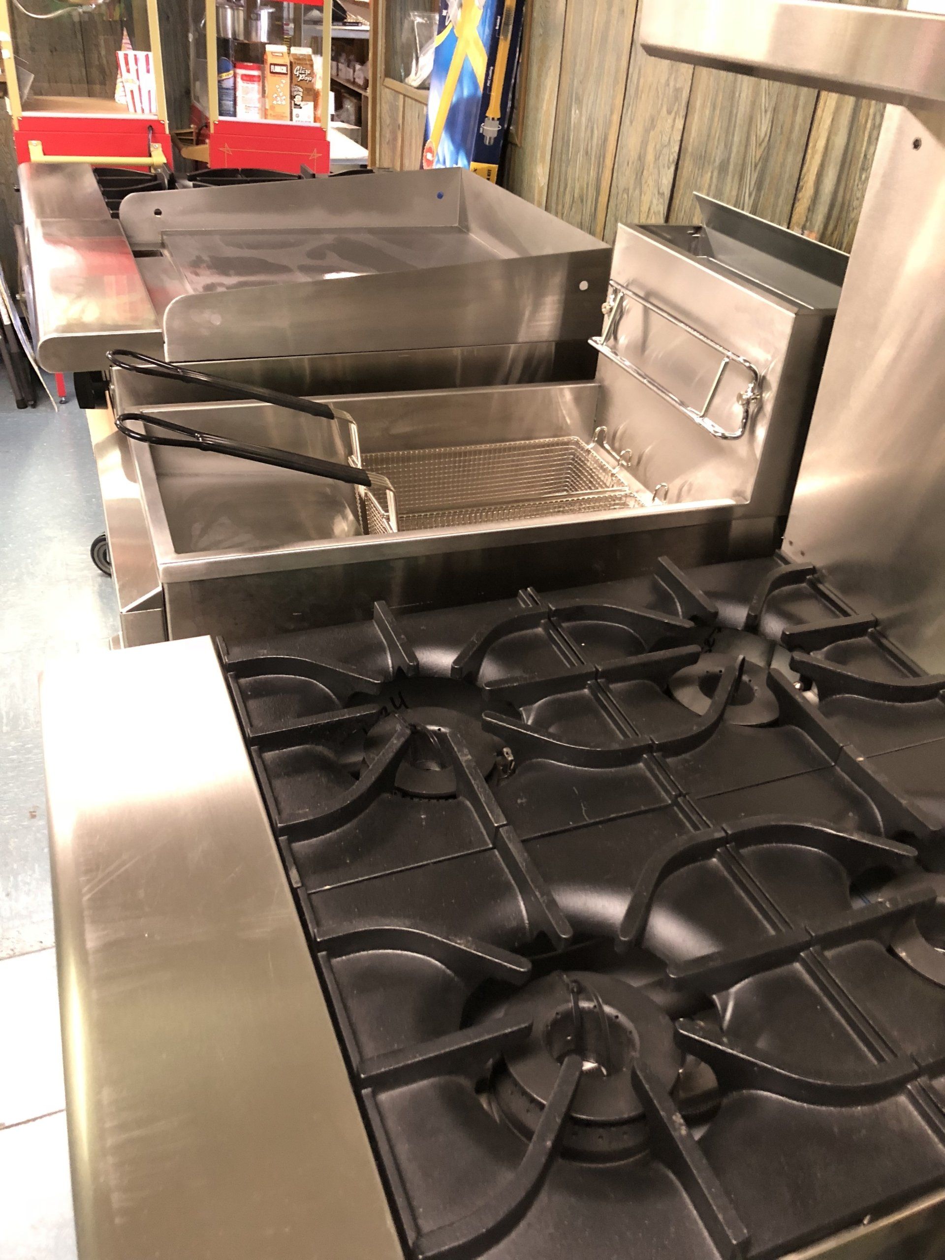 A stove with a fryer on top of it in a kitchen.