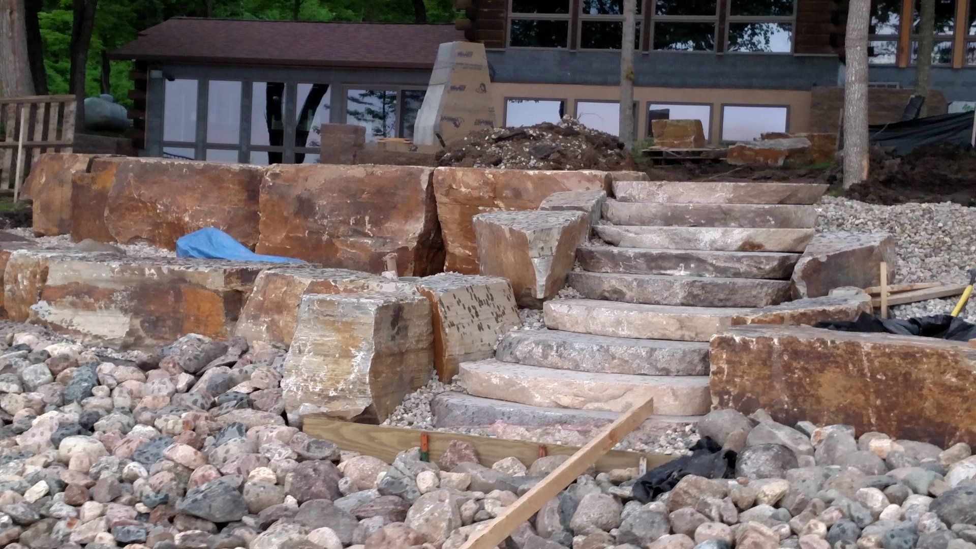 A pile of rocks and stairs in front of a house