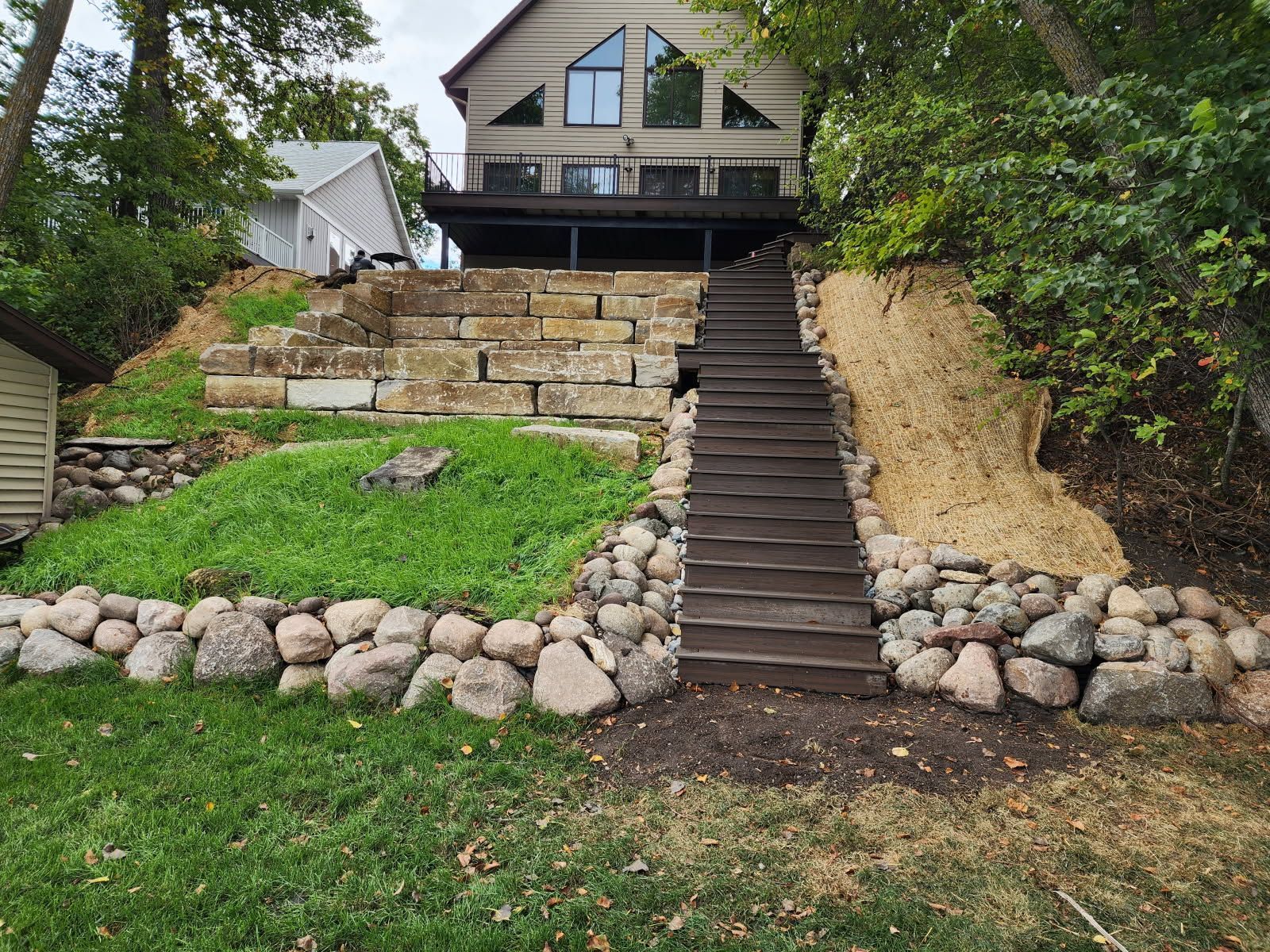 A house on a hill with stairs leading up to it.