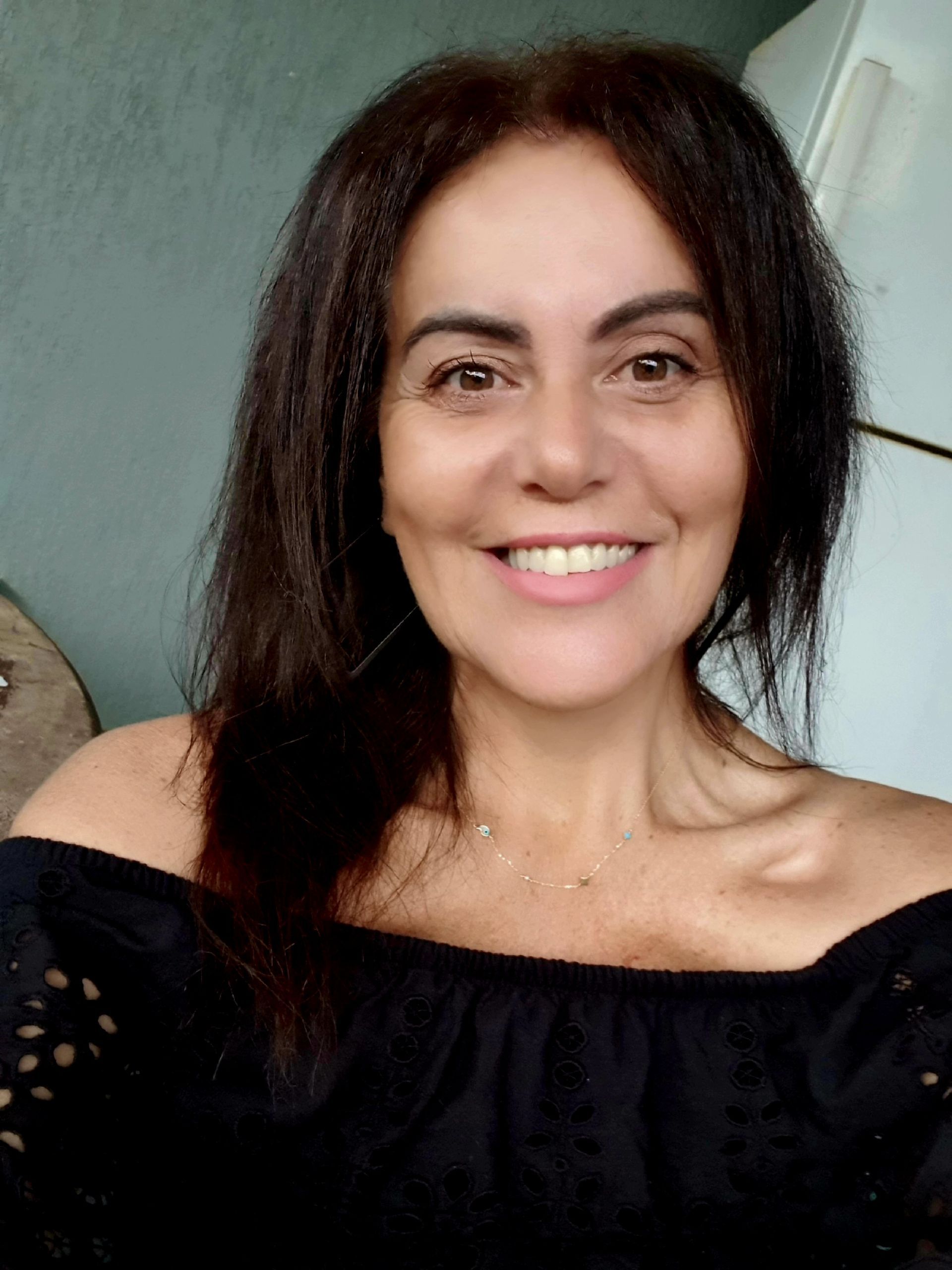 Woman smiling, wearing red polo shirt with 