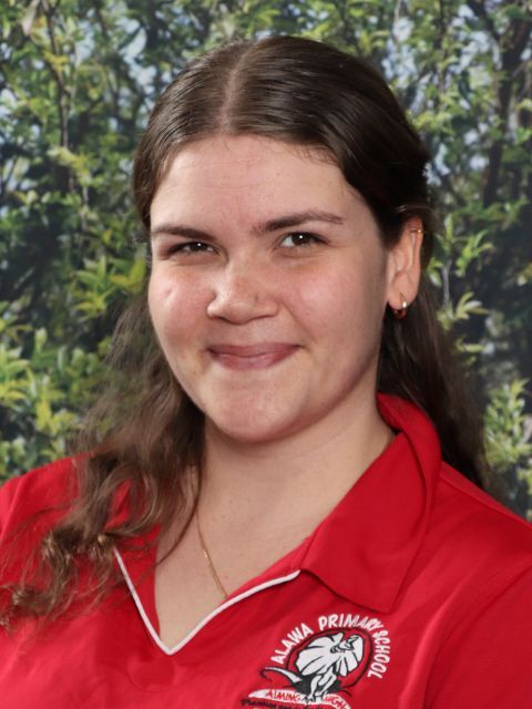 Woman smiling, wearing red polo shirt with 