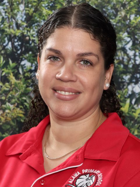 Woman with curly hair, smiling, wearing a red shirt with 