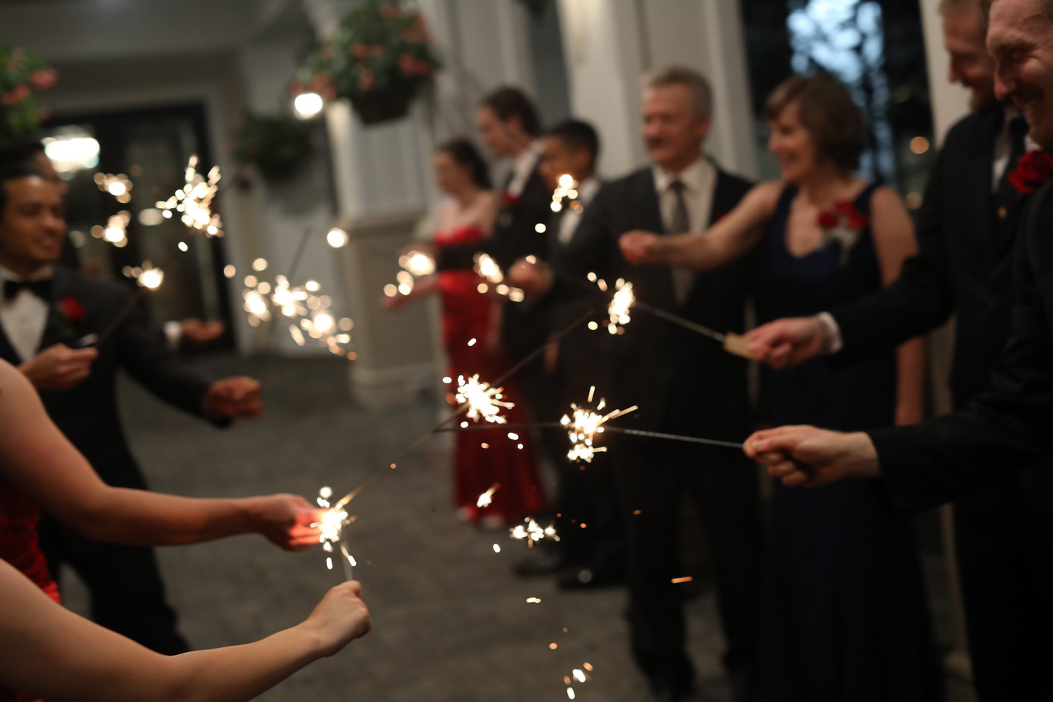 A group of people are holding sparklers in their hands