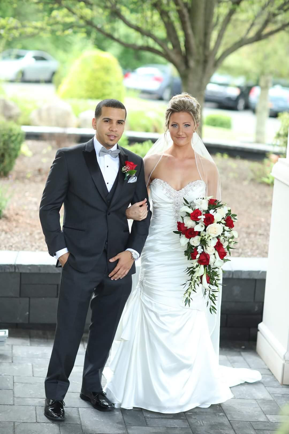 A bride and groom are posing for a picture on their wedding day