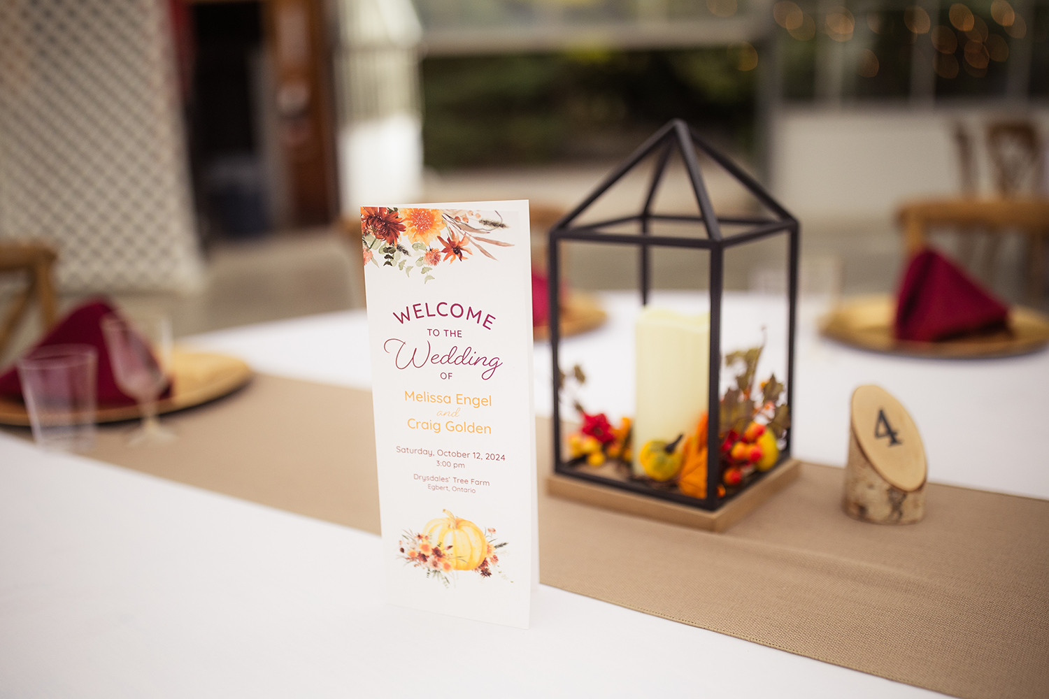 A table with a menu and a candle on it.