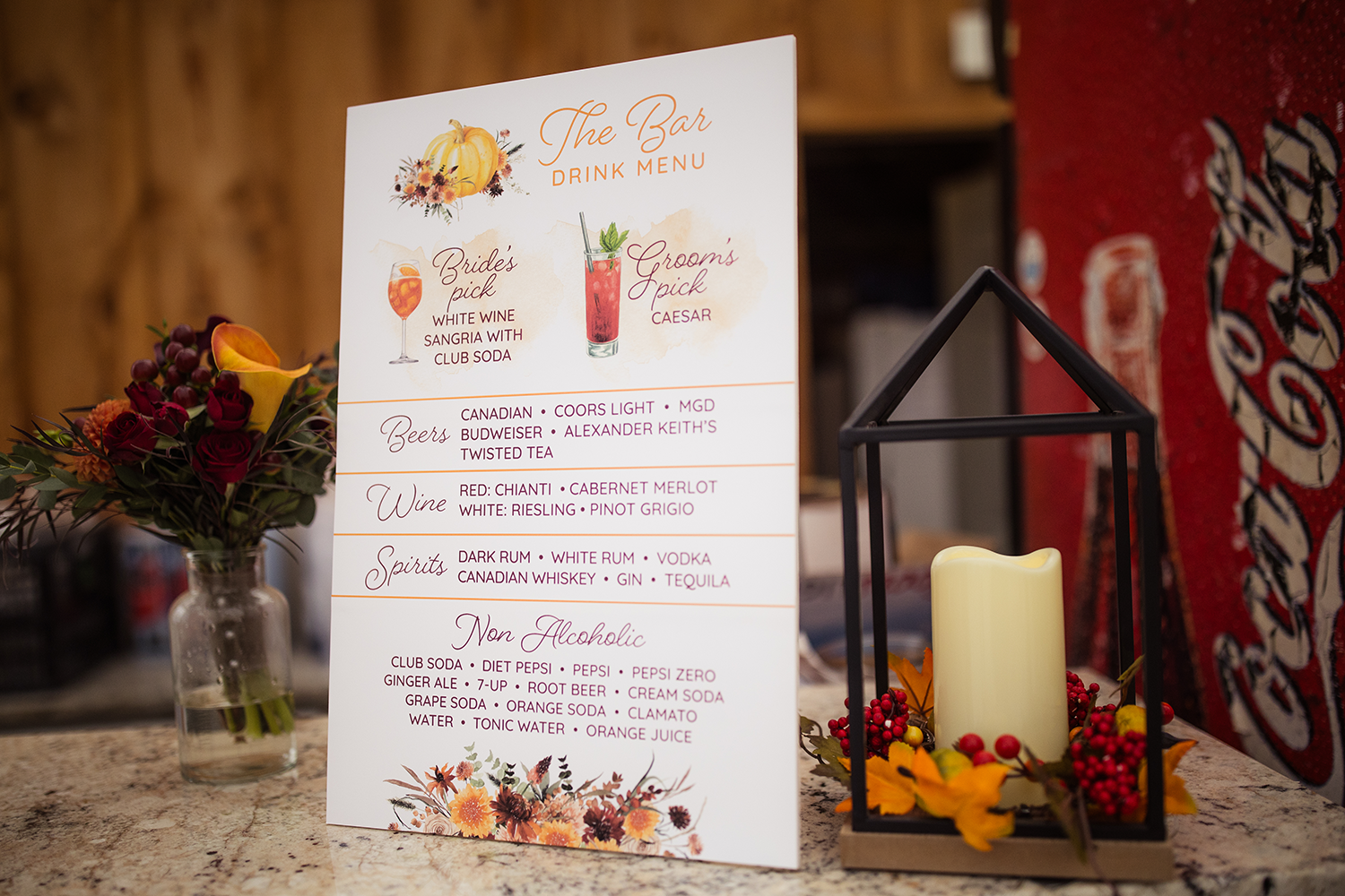 A menu is sitting on a counter next to a candle.
